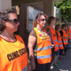 FILE - In this July 17, 2017 file photo, escort volunteers line up outside the EMW Women's Surgical Center in Louisville, Ky., the state's only abortion clinic. Anti-abortion groups are challenging a new Louisville law that creates a buffer zone around medical centers. It bars protesters from an area in front of a downtown abortion clinic. The new law passed by the Louisville Metro Council last May 2021 creates a 10-foot-wide zone outside healthcare facilities, including the EMW Women’s clinic. (AP Photo/Dylan Lovan, File)